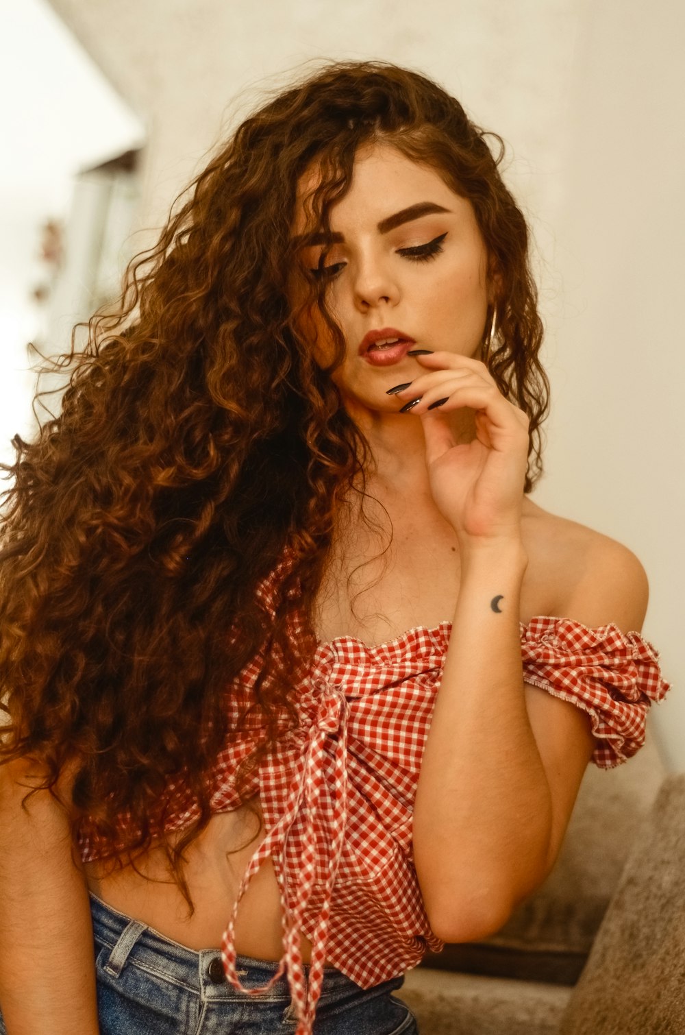 woman wearing red crop top inside room