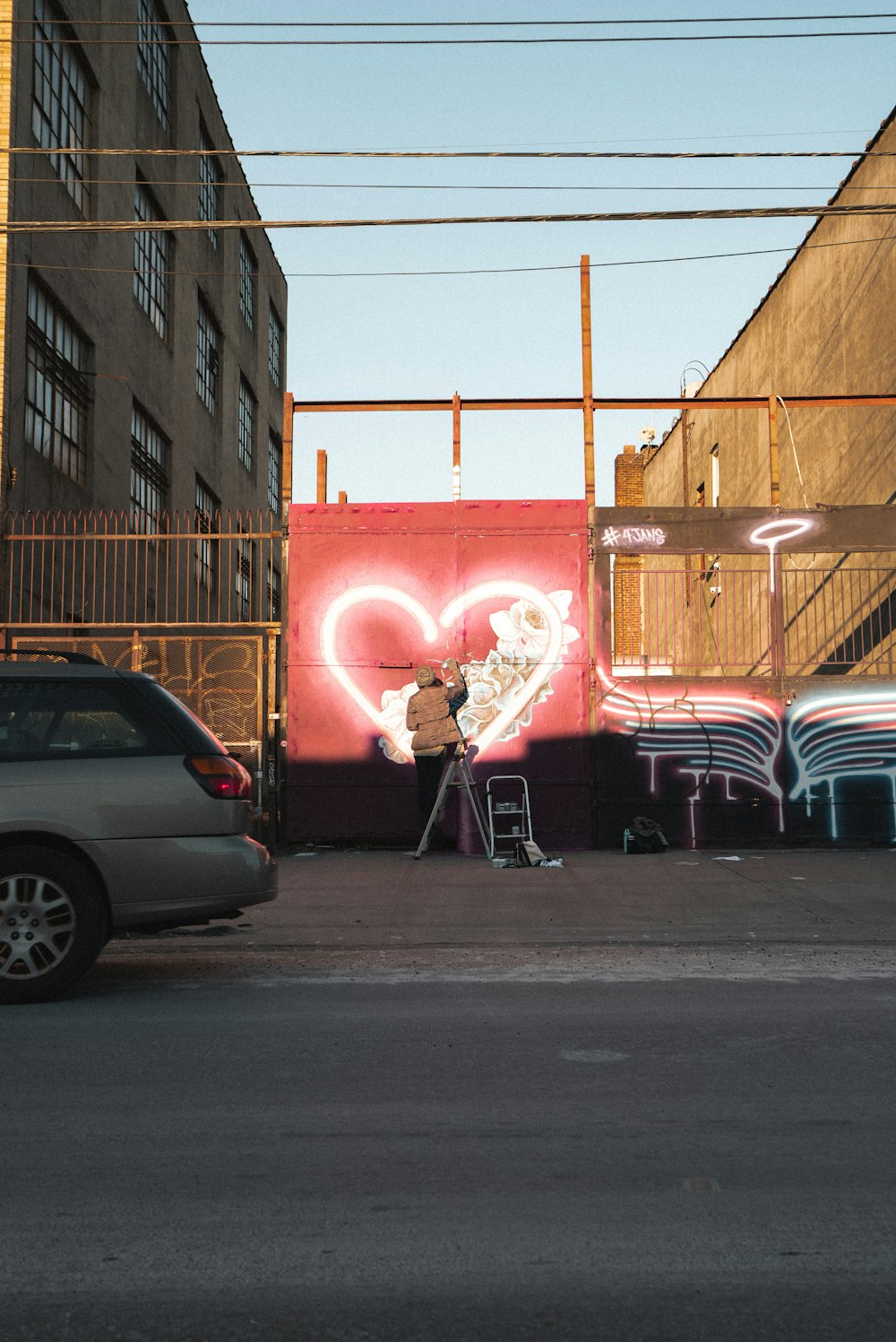 man drawing wall graffiti