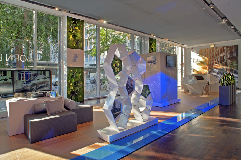 A warm and modern showroom interior with deep navy and suzuki red accents, showing friendly staff assisting customers.