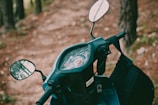 A close-up of a sleek scooter dashboard with the sea in the background.