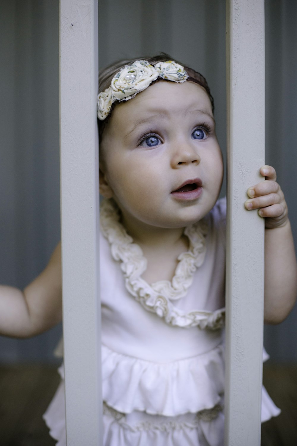 baby looking through panel