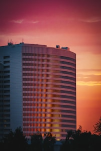 a tall building with a red sky in the background