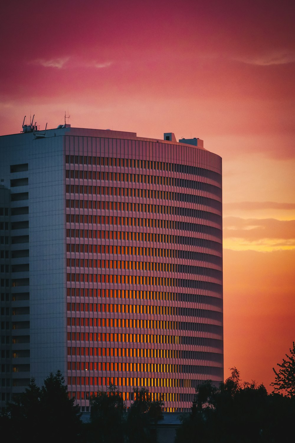 a tall building with a red sky in the background