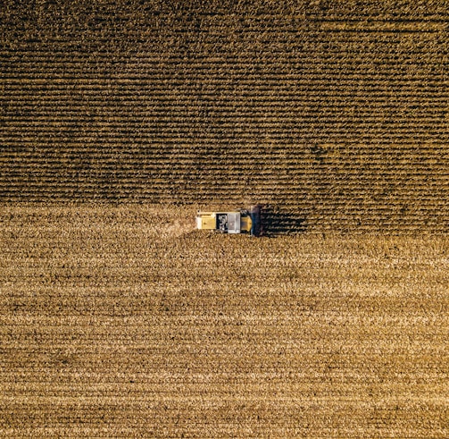 an aerial view of a farm house in a field