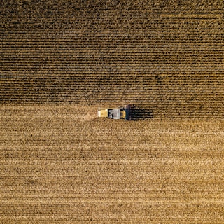 an aerial view of a farm house in a field