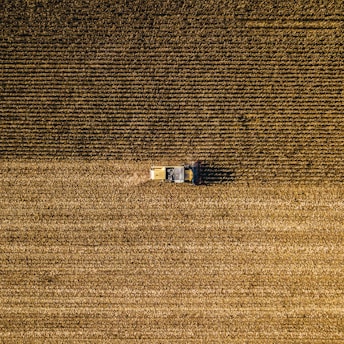an aerial view of a farm house in a field