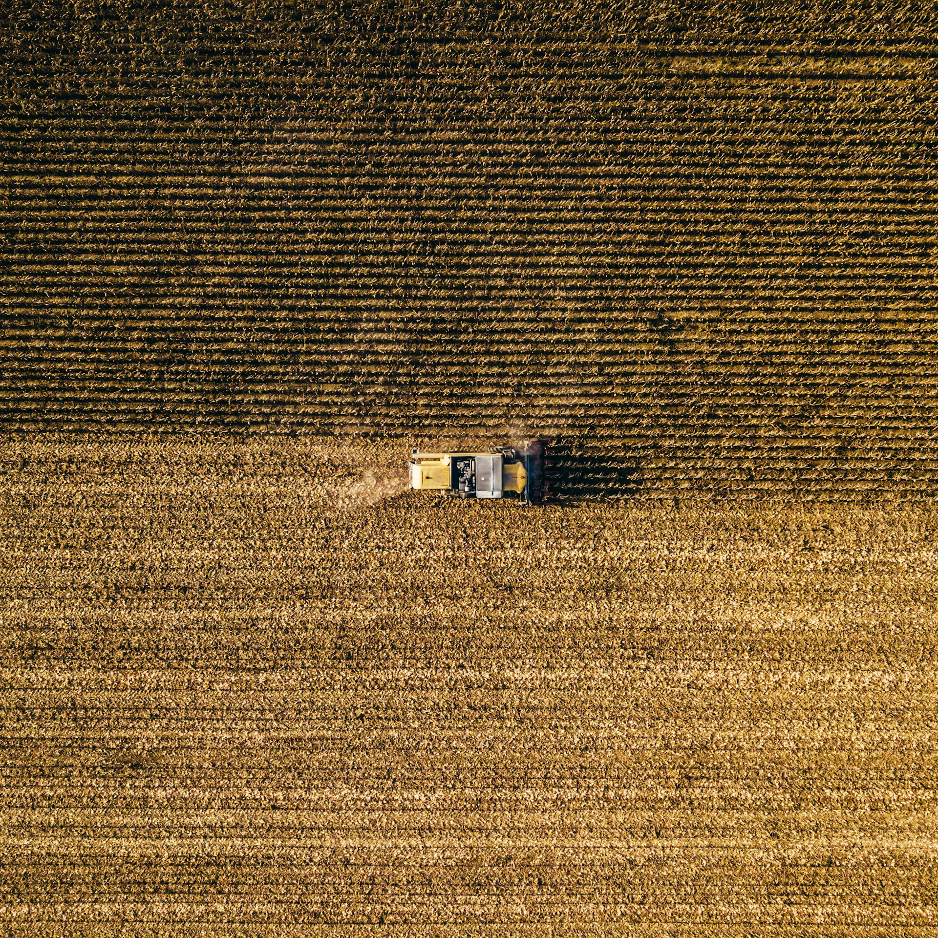 an aerial view of a farm house in a field