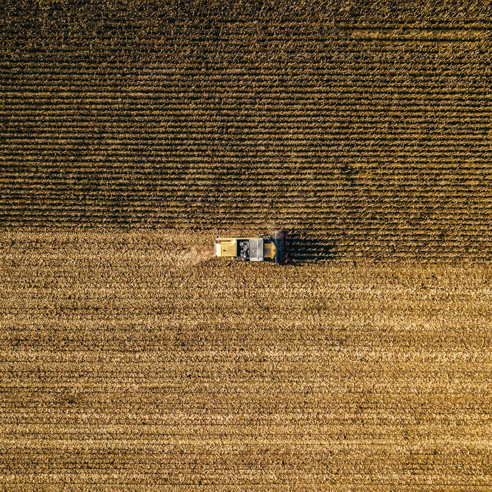 an aerial view of a farm house in a field