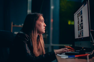 sitting woman using a computer on table