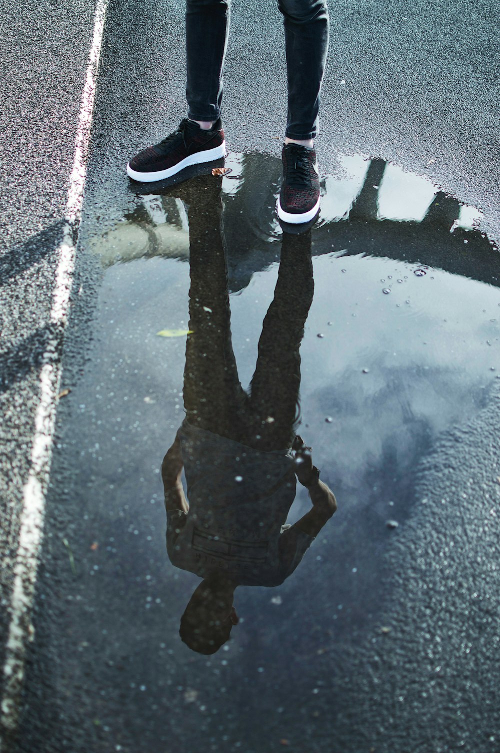 man standing on road during daytime