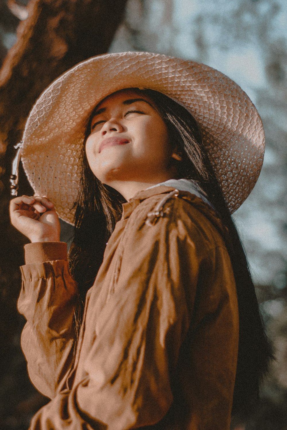 woman standing under tree during daytime