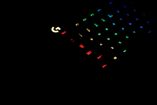 A vibrant shot of a gamer’s hands on a colorful RGB keyboard with neon lighting.
