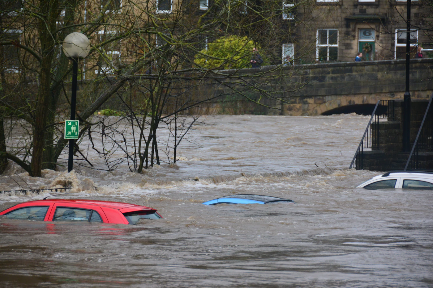 Flooded road with water covering the surface, calm daylight conditions