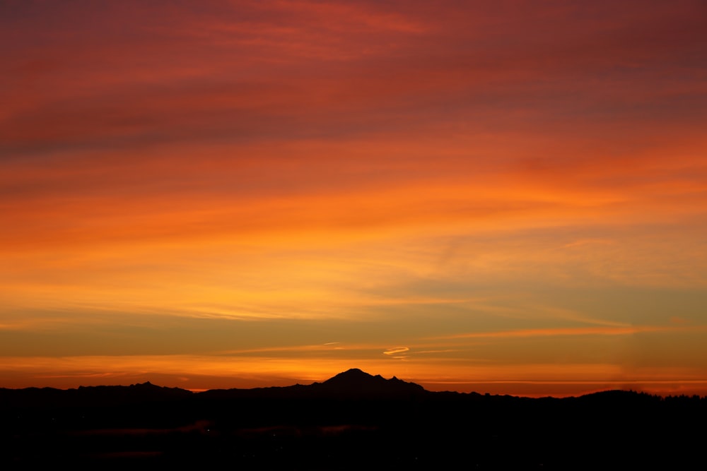 silhouette of mountain during sunset