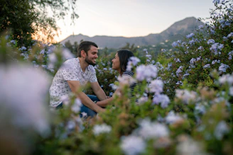 A cozy couple enjoying a private mountain picnic in Arang Kel surrounded by vibrant wildflowers.
