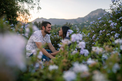 A cozy couple enjoying a private mountain picnic in Arang Kel surrounded by vibrant wildflowers.