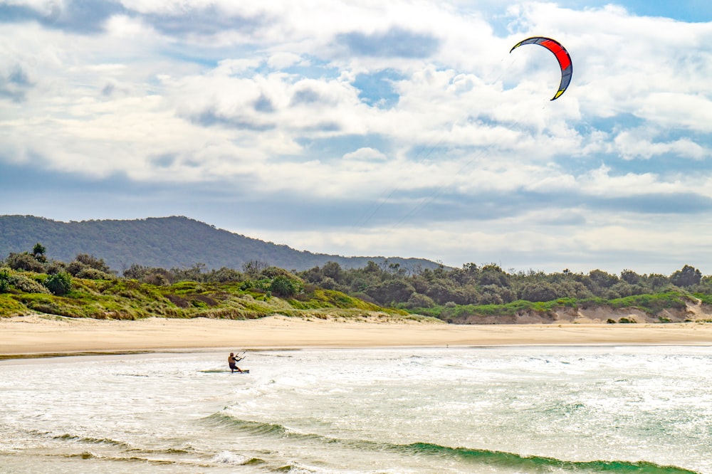 man parasailing by the beach