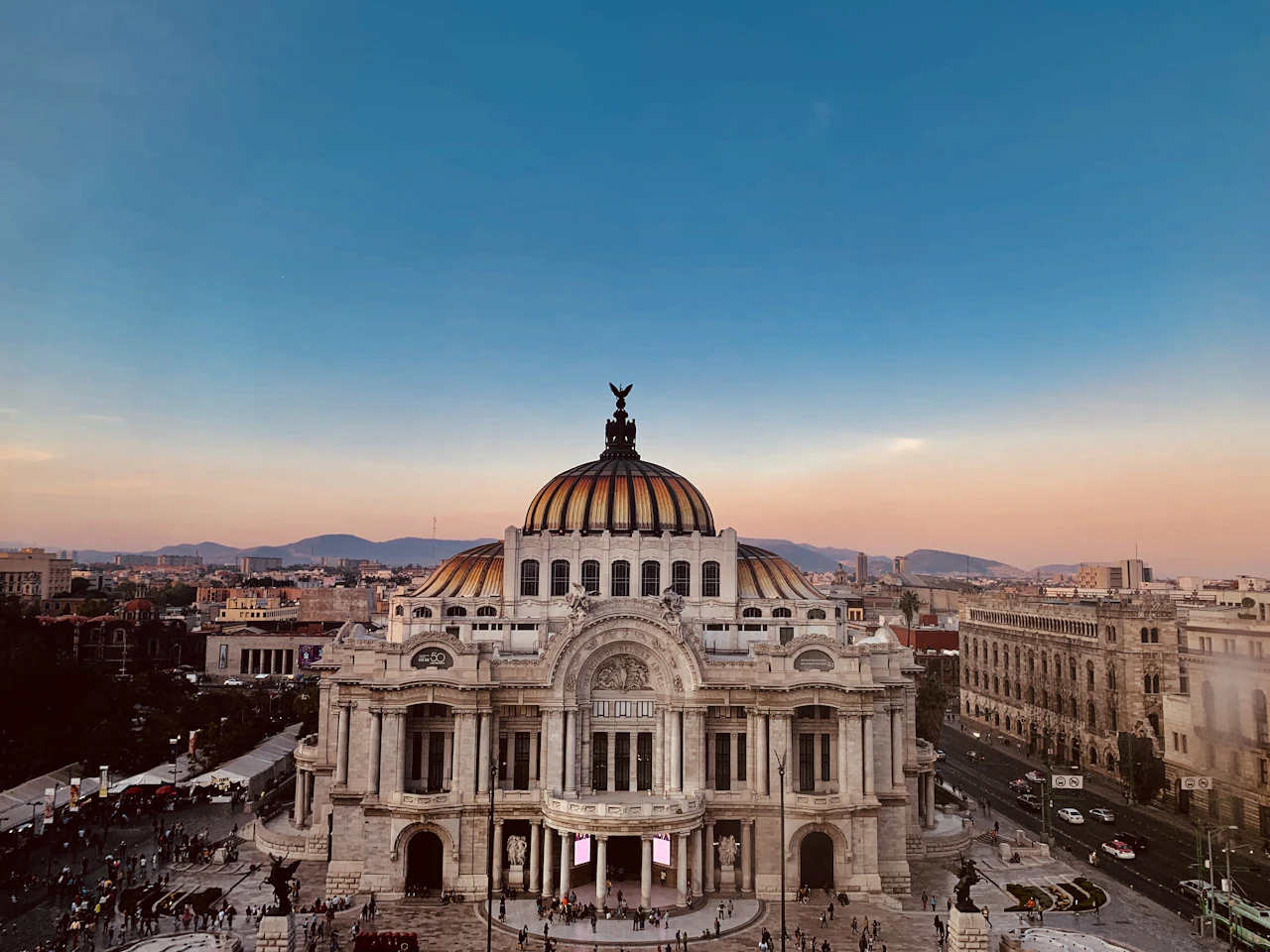 Palacio de Bellas Artes at dusk, the city fading into haze behind it