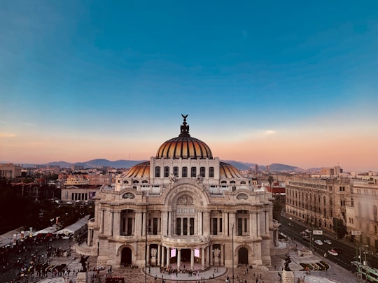 aerial photo of dome building under blue sky at daytime in Palacio de Bellas Artes Mexico