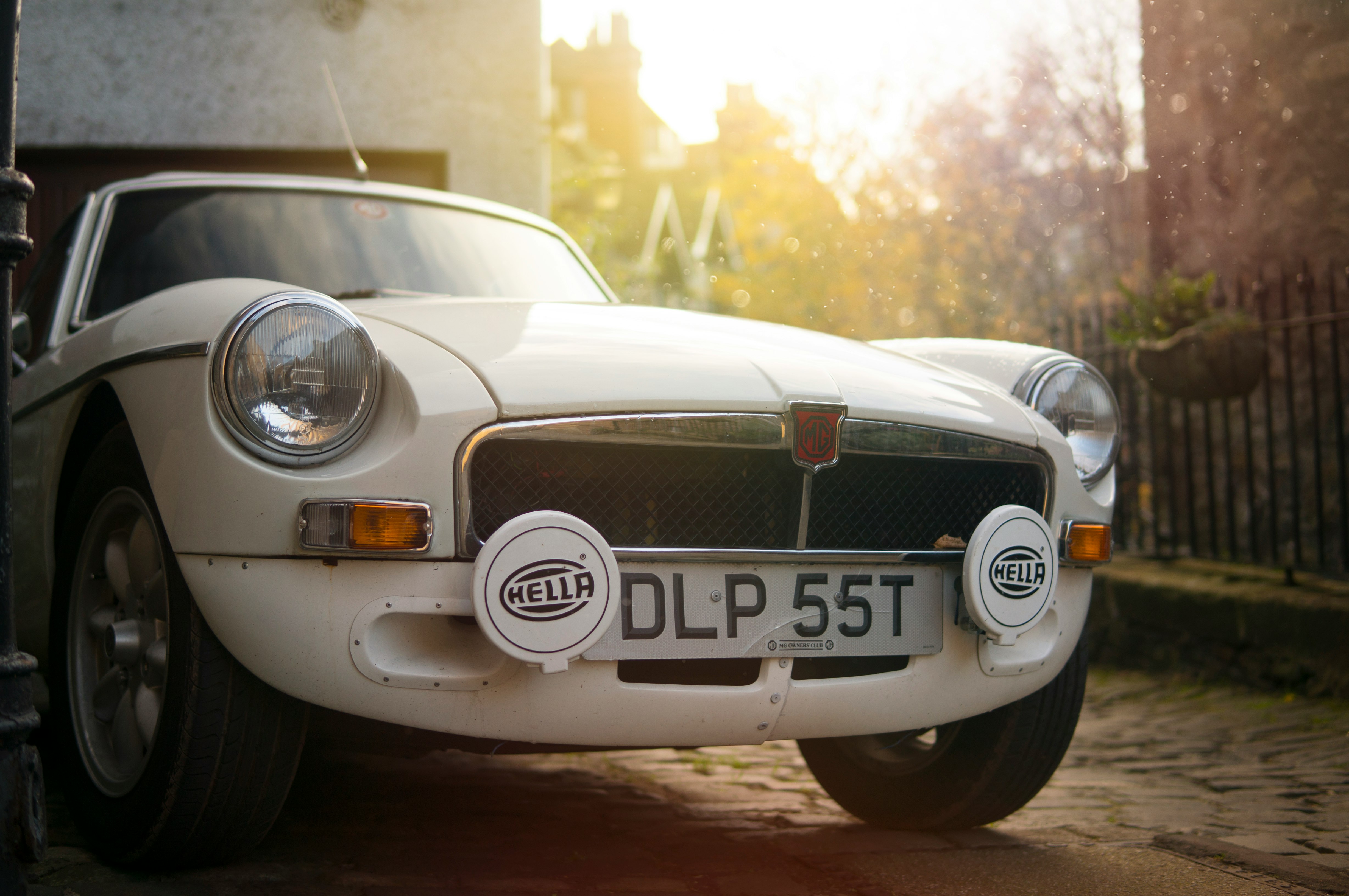 close-up photo of white classic vehicle parked during daytime