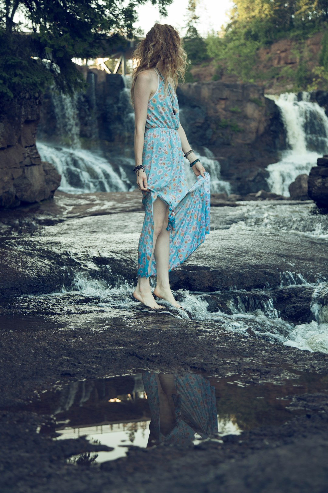 woman standing on rock under tree