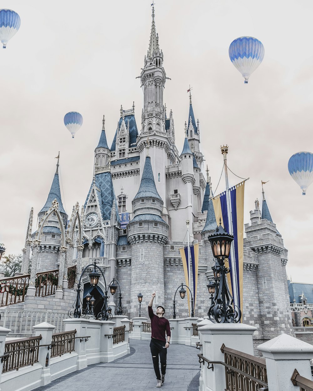 man standing beside Disneyland during daytime