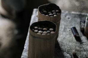 A titanium seed plate resting on a rustic wooden table, highlighting its sturdy fire-resistant design.