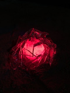 A mysterious ancient artifact glowing faintly under red light