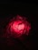 A glowing red rune pulsating with fiery energy on a dark background.