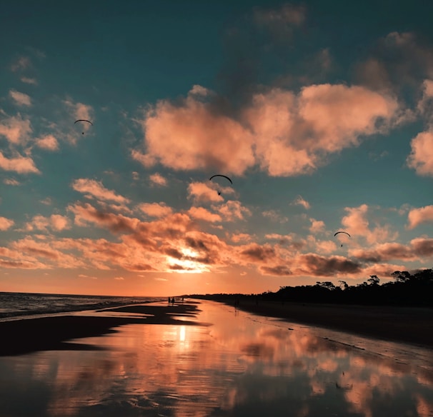 clouds reflected on body of water during golden hour