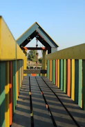 Photo of a colorful kidplay structure being assembled outdoors