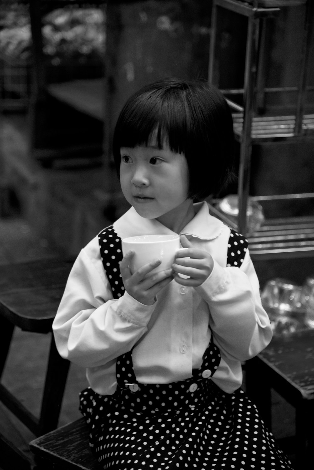 grayscale photography of girl in polka-dot skirt