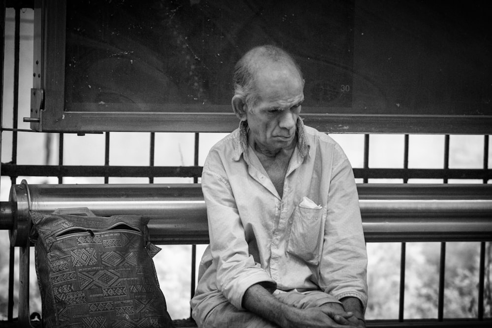 man wearing white dress shirt sitting on chair