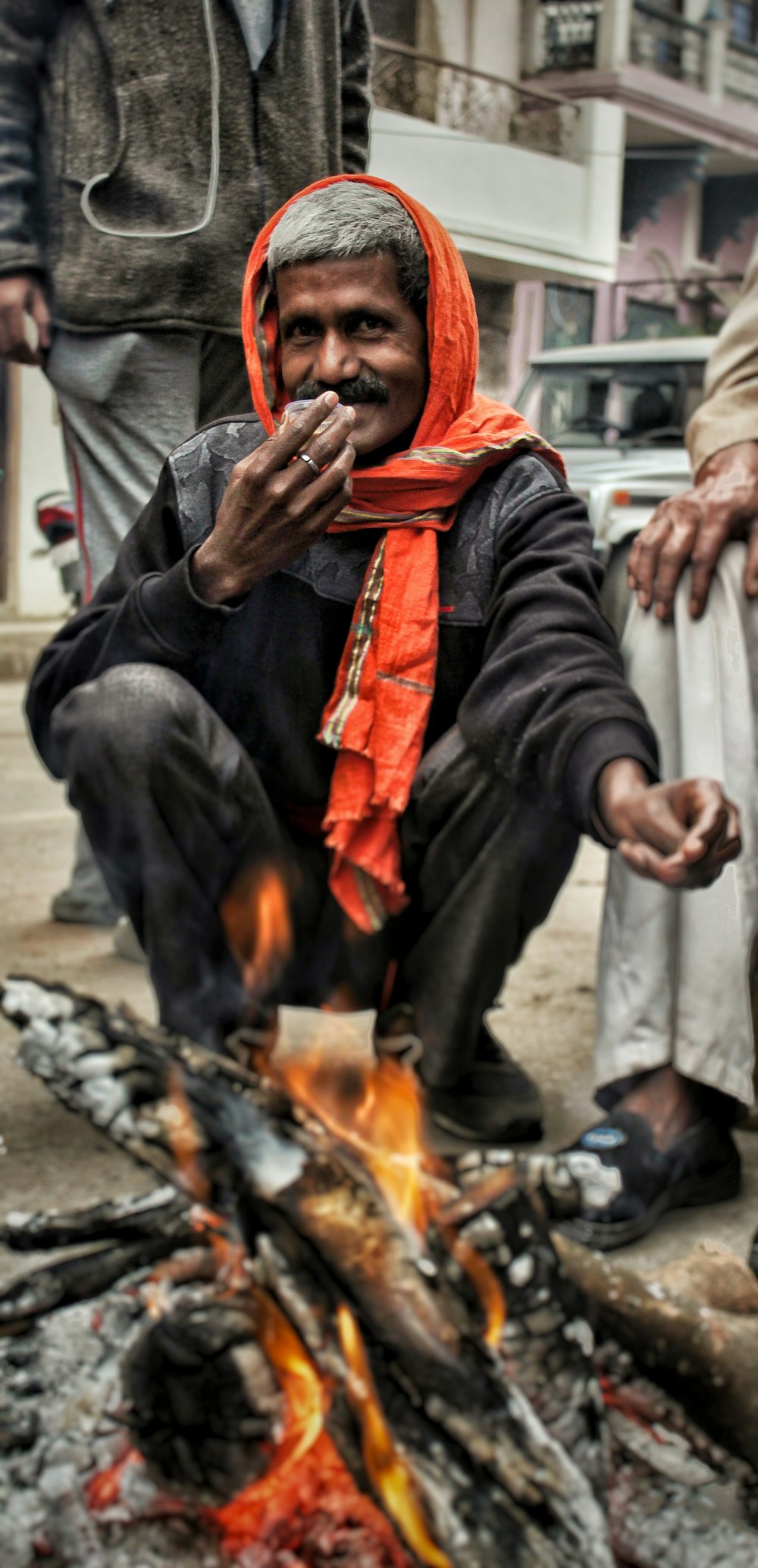 man sitting near bone fire
