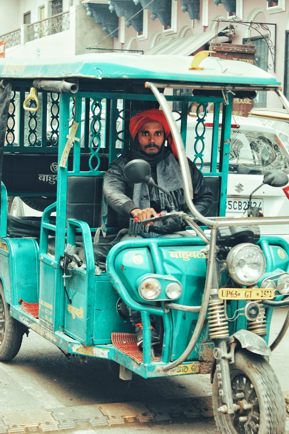 man driving auto-rickshaw during daytime