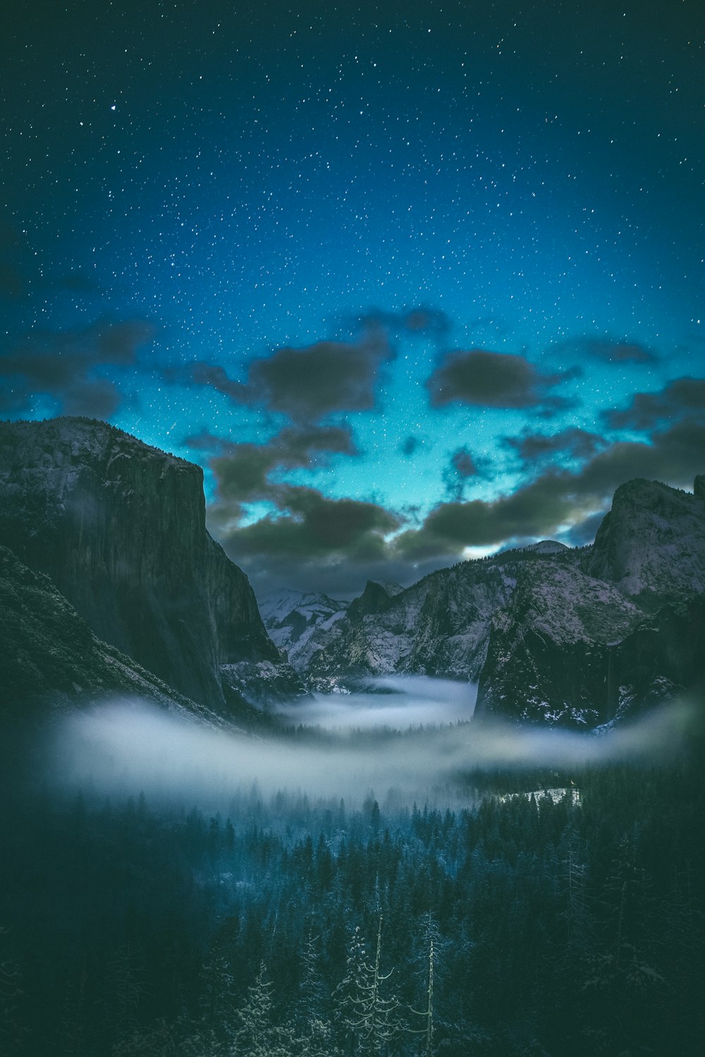 mountain range under nimbus clouds