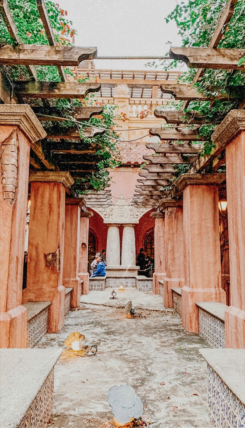 brown wooden pillars with plants