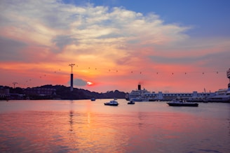 A colorful sunset view over Cartagena's historic skyline with boats ready for island tours.