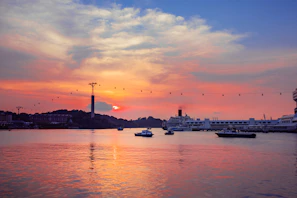 Sunset view over Funchal’s harbor with colorful boats gently bobbing in the water