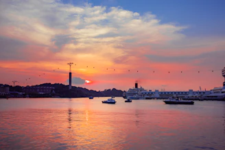 Sunset view over Funchal’s harbor with colorful boats gently bobbing in the water