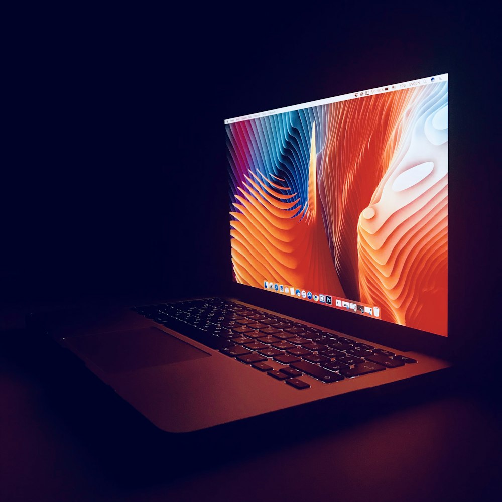 silver laptop computer on table