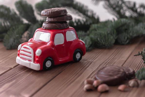 Colorful breakfast basket with assorted sweets and a small toy car on a bright tablecloth