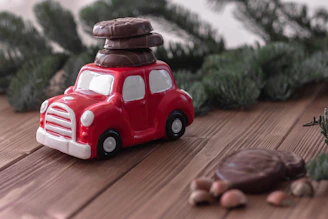 Colorful breakfast basket with assorted sweets and a small toy car on a bright tablecloth