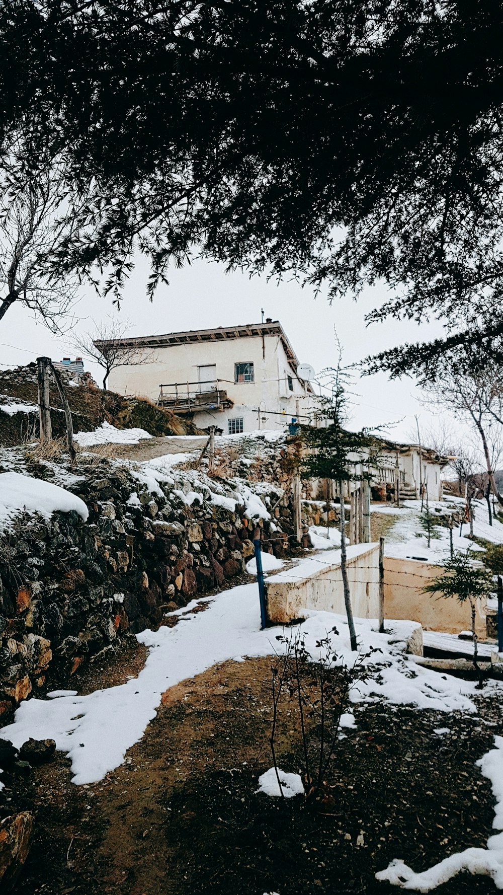 melting snow and white painted house