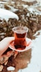 person holding tea glass