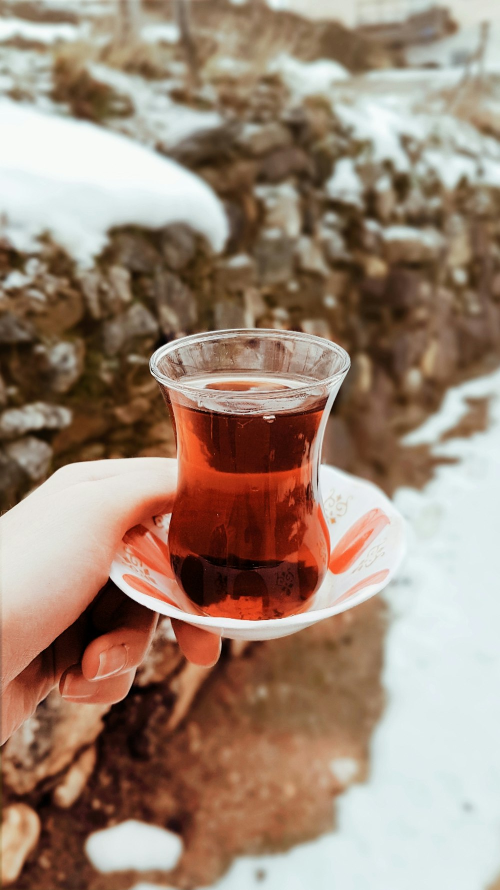 person holding tea glass