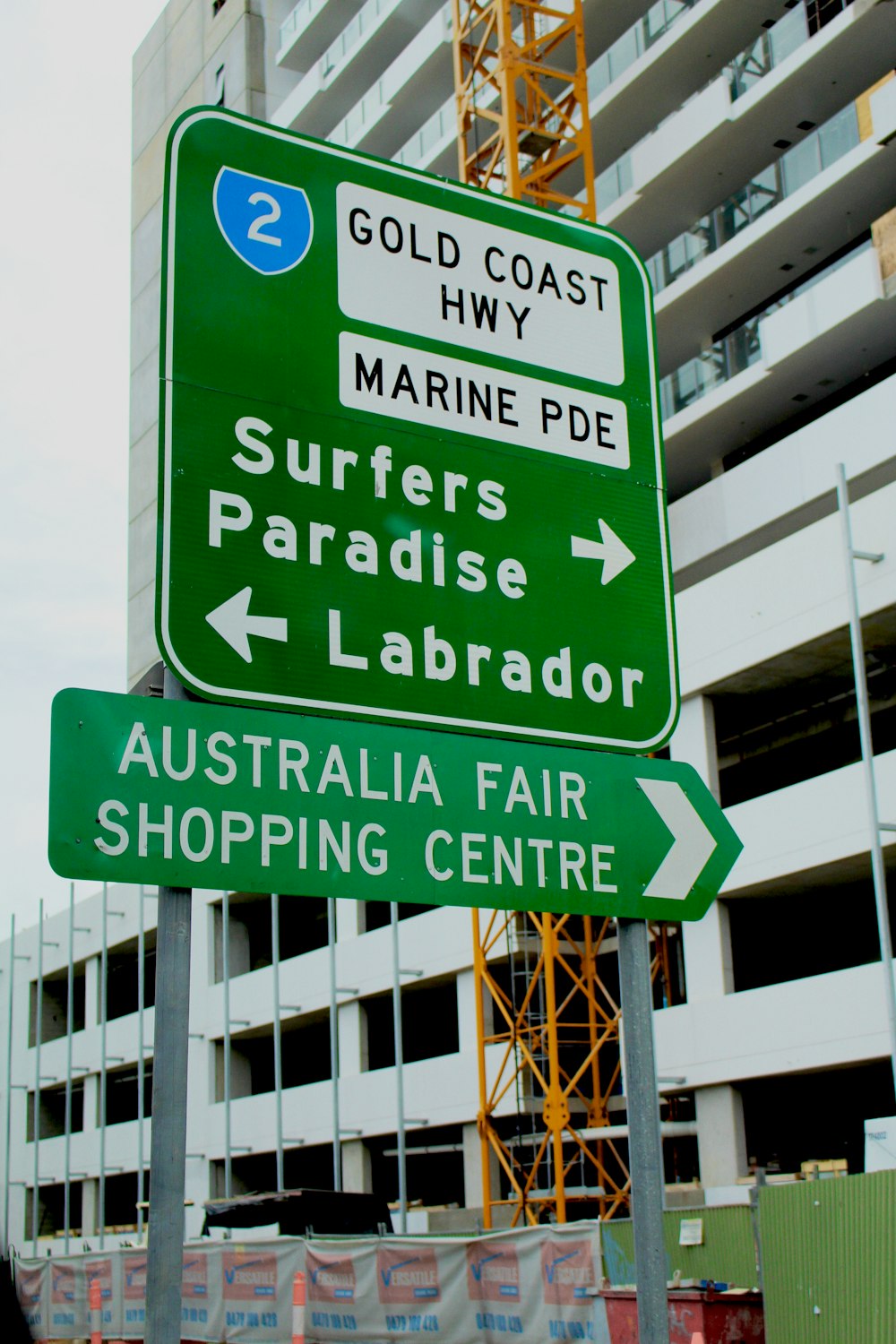 green and white road sign on daylight