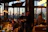 Close-up of a happy diner enjoying a flavorful meal in a dimly lit restaurant.