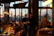 Close-up of a happy diner enjoying a flavorful meal in a dimly lit restaurant.