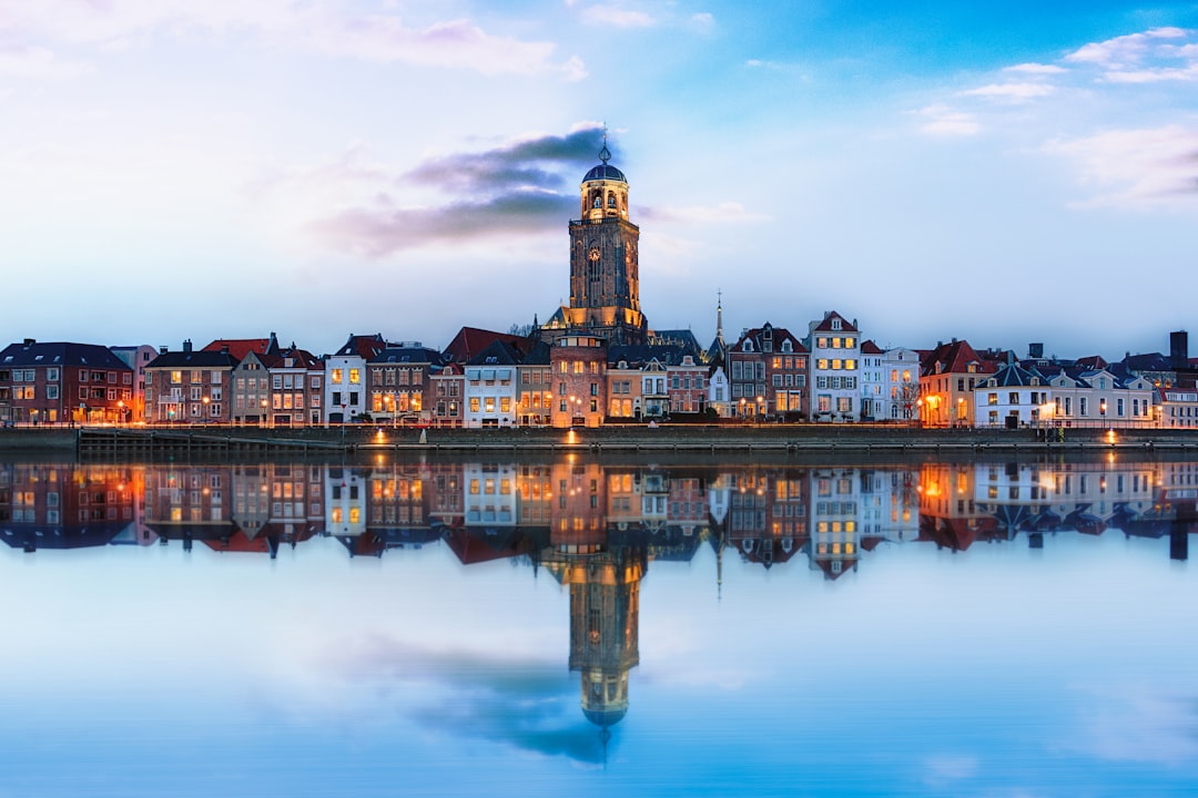 lighted buildings across placid lake